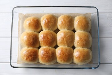 Wall Mural - Delicious dough balls in baking dish on white wooden table, top view