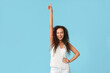 © Pixel-Shot - Happy young African-American woman on blue background