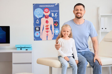 Poster - Little girl with her father sitting on couch at endocrinologist's office