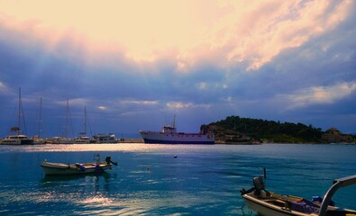 Wall Mural - Boats in harbor with rays of sun nautical background