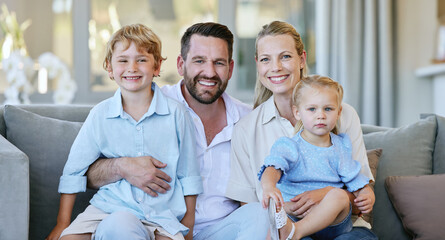 Poster - Portrait, family and happy children on sofa for love, care or bonding together with parents in home. Dad, mom and smile of kids in living room for relax, connection or support with siblings in house