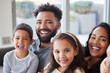 © peopleimages.com - Happy family, portrait and sofa with children for selfie, memory or photography in relax at home. Father, mother and kid or siblings with smile in joy for morning, moment or picture together at house