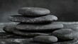© Emin - Pile of gray massage stones on a dark background