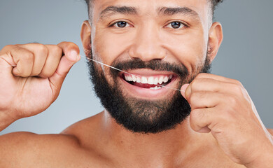 Poster - Dental care, floss or portrait of man in studio for hygiene, plaque removal or clean with thread. Face, male person or oral wellness on gray background for breath, morning routine or gum gingivitis