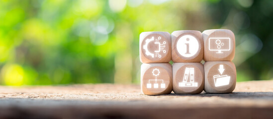 Wooden blocks with ITIL icons representing information technology infrastructure library concepts on a natural, blurred background.