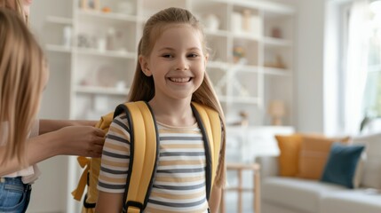 Wall Mural - A girl is smiling and wearing a yellow backpack