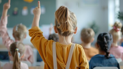 Wall Mural - A girl in a yellow shirt raises her hand in a classroom