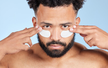 Wall Mural - Man, eye pad and skincare in studio portrait with product for anti aging, cosmetics or beauty by blue background. Model, person and patch for dermatology, change and health with facial transformation