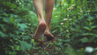 © Gita - A person walking barefoot on a forest trail, capturing the serene and natural atmosphere of the woods.