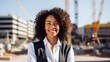 © CStock - African American female architect confidently smiling with construction site background