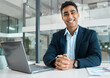 © peopleimages.com - Portrait, man and smile with laptop for business, research and planning for stock market at desk Financial advisor, hands and trading or happy in office for career, fintech and technology in agency
