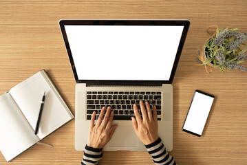 Wall Mural - blank white desktop screen monitor of laptop computer with women are typing keyboard. top view,above