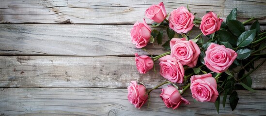 Poster - Pink roses bouquet on wooden backdrop with copy space image.