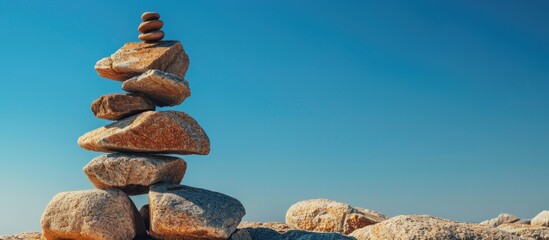 Poster - Mountain made of rocks stands against a clear blue sky backdrop of a copy space image.