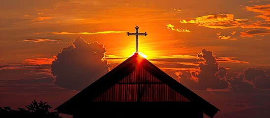 Poster - Sunset silhouette of church roof with metal cross, vibrant orange clouds, and sun; room for text in image.