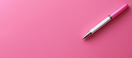 Fototapete - Pink background showcasing a white sheet of paper with a pen in the frame, ideal for adding text, featuring copy space image.