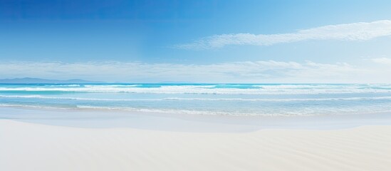 Poster - Beach waves during low tide against a clear blue sky with a vast expanse of sand, creating a serene and picturesque scene for a copy space image.