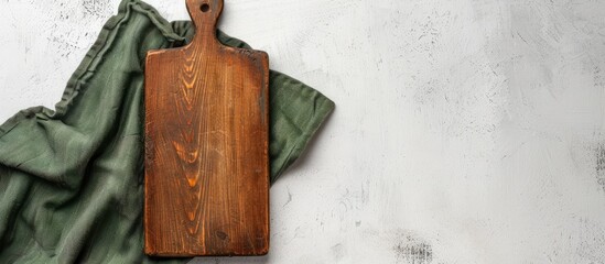 Aufkleber - A vintage rectangular cutting board with a handle is placed on a white table beside a green towel, accompanied by a blank area on the left for text or design in a copy space image.
