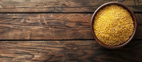 Poster - Top view of a wooden table with a bowl of raw bulgur, providing a clear space for text in the image.