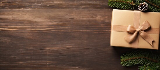 Aufkleber - Top view of a handcrafted Christmas gift box in kraft paper on a wooden surface, with ample copy space for text, accompanied by a greeting card.