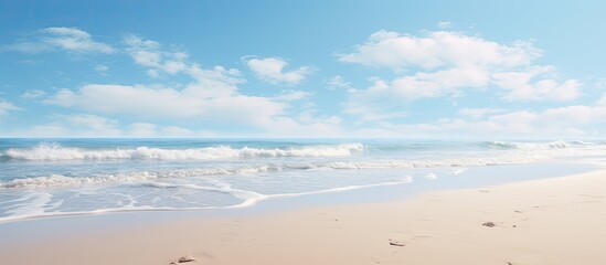 Poster - Beach waves during low tide against a clear blue sky with a vast expanse of sand, creating a serene and picturesque scene for a copy space image.