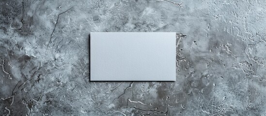 Aufkleber - Gray paper business card placed on a textured gray concrete background with space for text or design, shot from above in a minimalistic style.
