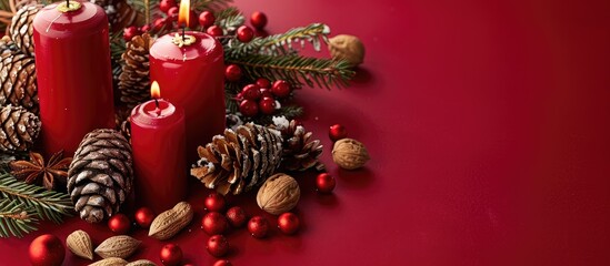 Poster - Christmas-themed decorations featuring candles, pine cones, and nuts on a red backdrop with a copy space image for the Xmas concept.