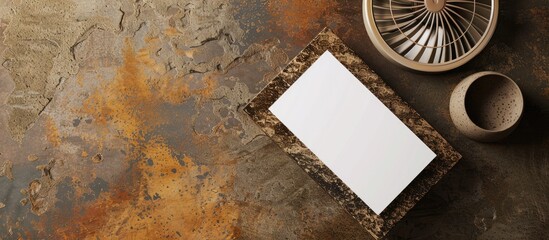 Aufkleber - Top view of a modern business card mockup on a granite surface next to a fan on a brown grunge background, creating a stylish template for branding with copy space image.