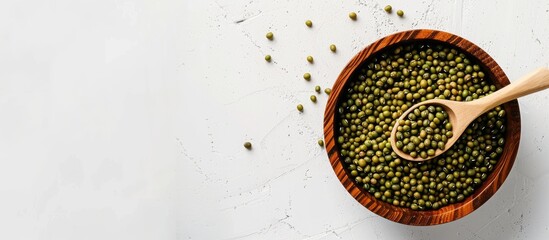 Aufkleber - Mung beans in a wooden bowl with a spoon on a white background Ample copy space available in the image