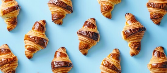 Aufkleber - Top down view of a tasty continental breakfast featuring numerous fresh chocolate filled croissants on a blue backdrop ideal for adding text alongside the image. with copy space image