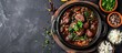 © vxnaghiyev - Top down view of a traditional Brazilian Feijoada dish with copy space image