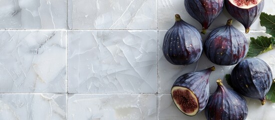 Poster - Flat lay of fresh ripe purple figs on a white tiled table with space for text in the image. with copy space image. Place for adding text or design