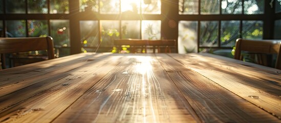 Wall Mural - Sunlight streaming onto a wooden table creating a warm and inviting ambiance with room for a copy space image