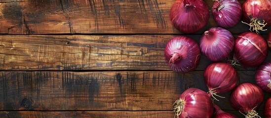 Aufkleber - Red Onions on a bright wooden surface creating a backdrop for text with a focused view from above suitable for a copy space image