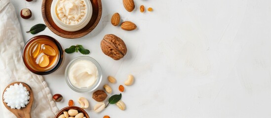 Wall Mural - argan and macadamia oil creme shampoo and nuts displayed on a white background with copy space image