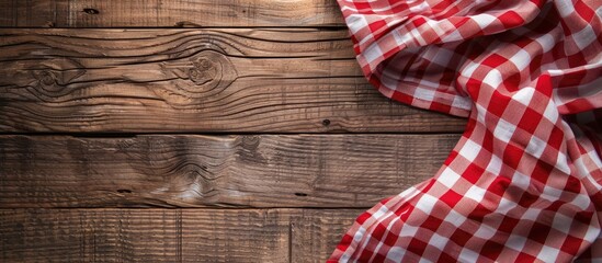 Poster - Top down view of a checkered tablecloth on a wooden table with ample copy space for text in the image