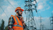 © Oleksiy - Electrical engineer with walkie talkie near high voltage tower