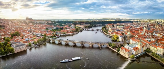 Wall Mural - Panoramic aerial view of the city scape of Prague with old town, Charles Bridge, Vltava River and Castle during a summer sunset