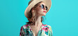 © Porechenskaya - Girl in a summer look, sunglasses and hat against a blue wall. Ideal advertising for accessories and eyewear stores.