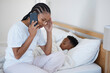 © peopleimages.com - Black mom, boy and sick in phone call on bed for medical care, service and book appointment with doctor. People, parent and kid at home with worry or stress for illness, flu and infection or virus