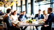 © N7 - Business Lunch Blur: A blurred restaurant setting with professionals having a business lunch, perfect for networking and casual business themes.