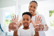© peopleimages.com - Black mom, boy and smile for hands with soap in home for hygiene, care and support with child development. Parent, kid and happy or excited on portrait with handwashing for germs and bacteria