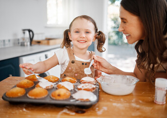 Wall Mural - Baking, family and decorating with mother, daughter and learning cooking in home kitchen. Food, kids and help with girl and mom happy with muffins, cupcakes and icing results for bonding together