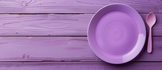 Wall Mural - Light wooden background with a purple plate on it creating a serene image with a copy space image