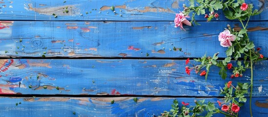 Fototapete - Blue painted wooden planks adorned with flowers providing a space for text within the copy space image