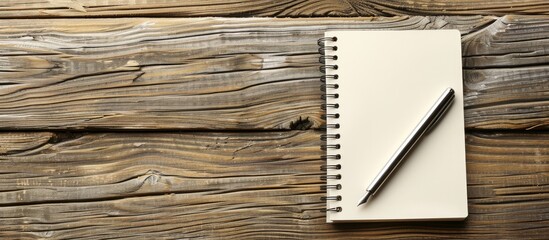 Aufkleber - Office wooden table with a pen placed on a blank notepad offering a copy space image