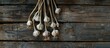 © Gular - Wooden table showcasing fresh garlic bulbs with long stalks offering ample copy space for customization