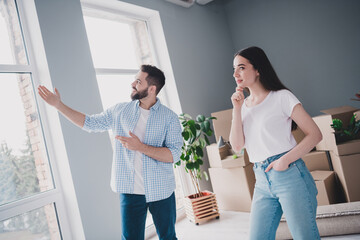 Wall Mural - Photo of two young partners show room think relocating moving box package new modern flat indoors