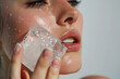 © AnaBeln - closeup of a causasian woman rubbing ice in her face. Space for copy