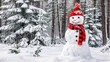 © Korawan - A snowman wearing a red hat and a red and black scarf stands in the snow